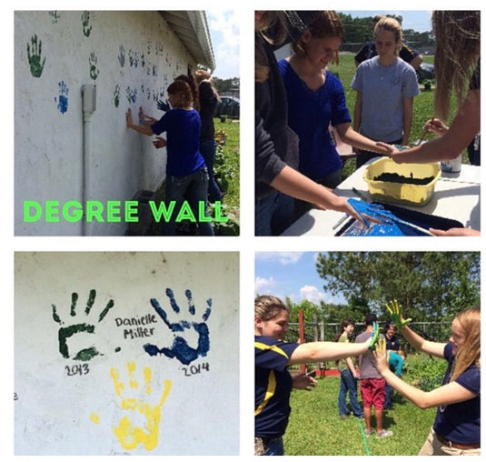 Students paint their palms green, blue, or yellow depending on what level of degree they've earned through the FFA and then press their hand onto the degree wall and add their name.
